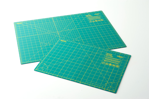 Images shows two green cutting mats of different sizes on a white background.