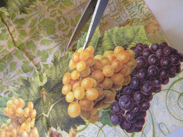 Cut grape  and leaf images (or images of your choice) from the paper napkin, making sure to cut through both layers. 