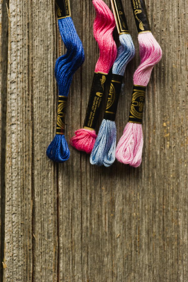 Image shows four brightly colored embroidery flosses Image shows four brightly colored embroidery flosses