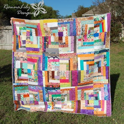 Image shows Jen's Quarter Square Log Cabin Scrap Quilt in full (photographed outside). Image shows Jen's Quarter Square Log Cabin Scrap Quilt in full (photographed outside).