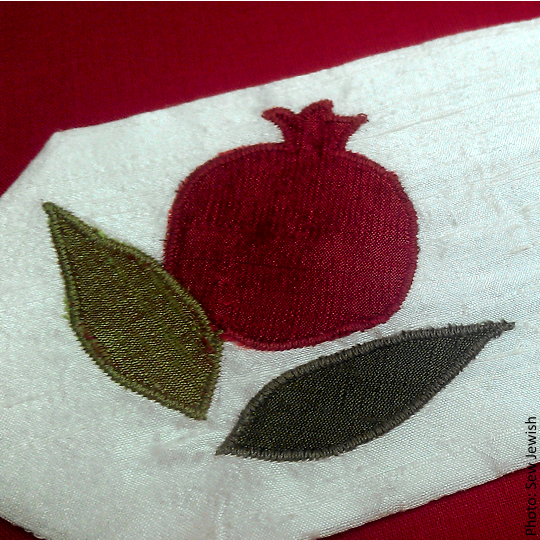 Image shows the Pomegranate Silk Applique made with straight point needles.