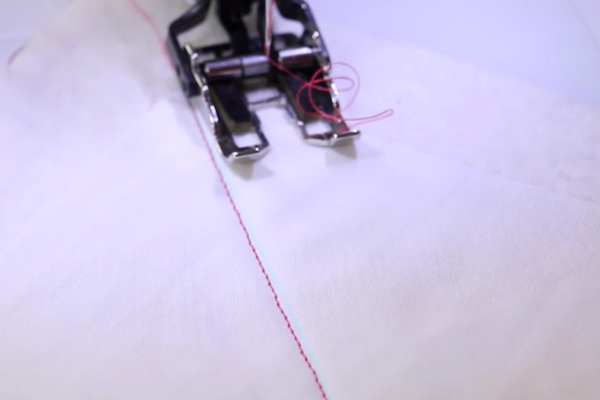 Image shows a close up of a machine starting to sew the grid design on fabric.