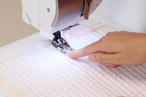 Image shows a machine sewing the matchstick design.