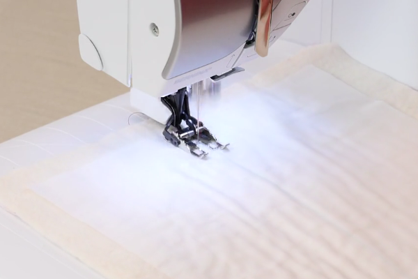 Image shows a machine sewing the straight line design.