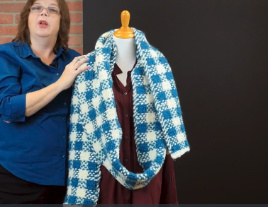 Image shows the Breezy Wrap Scarf tying example, step 2.