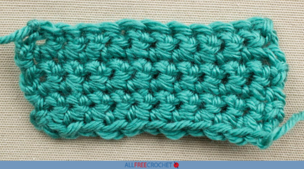 Image shows a single crocheted swatch of green yarn.