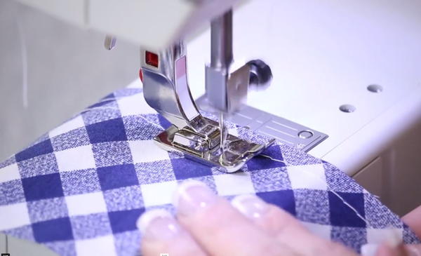 Image shows the basting stitch being sewn on a sewing machine.