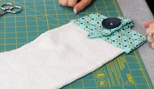 Image shows the finished towel with loop buttoned.
