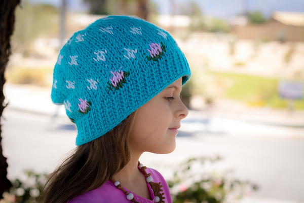 Image shows a child wearing the Rainy Spring Beanie outside.