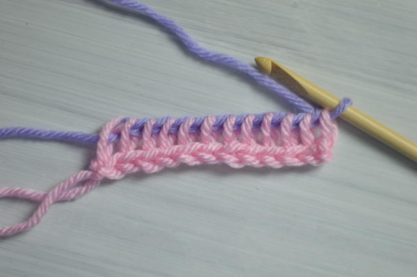 Image shows the fifth step in changing color at the beginning of the return pass in Tunisian crochet.