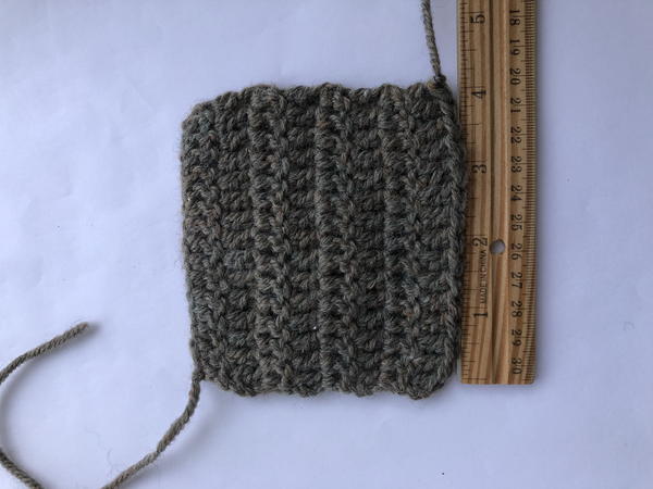 Image shows a crochet swatch on a light background. There is a wooden ruler measuring the right side.