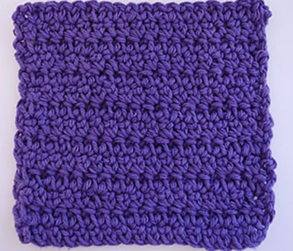 Image shows a purple extended single crochet stitch swatch on a light gray background.