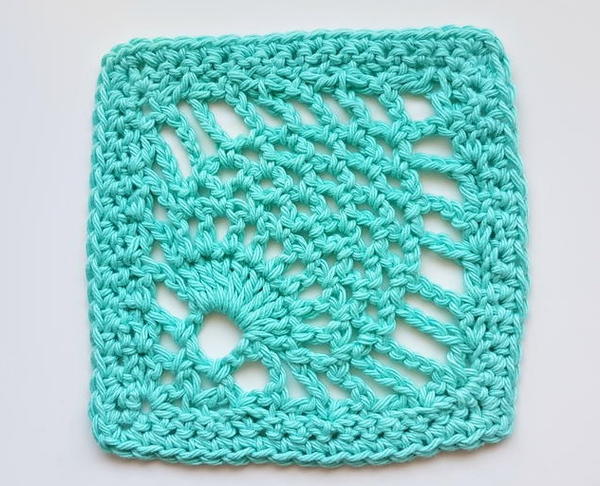 Image shows a teal pineapple stitch crochet swatch on a light gray background. 