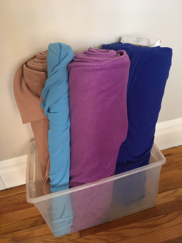 Image shows a clear tub full of fabric.