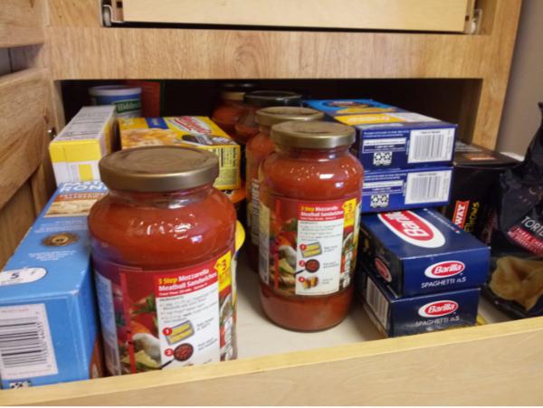 A pantry stocked with dried pasta and pasta sauce