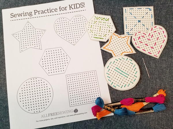 Image shows the printed sewing card sheet and cut out shapes that were sewn using different-colored embroidery floss. Three embroidery floss packages are below.