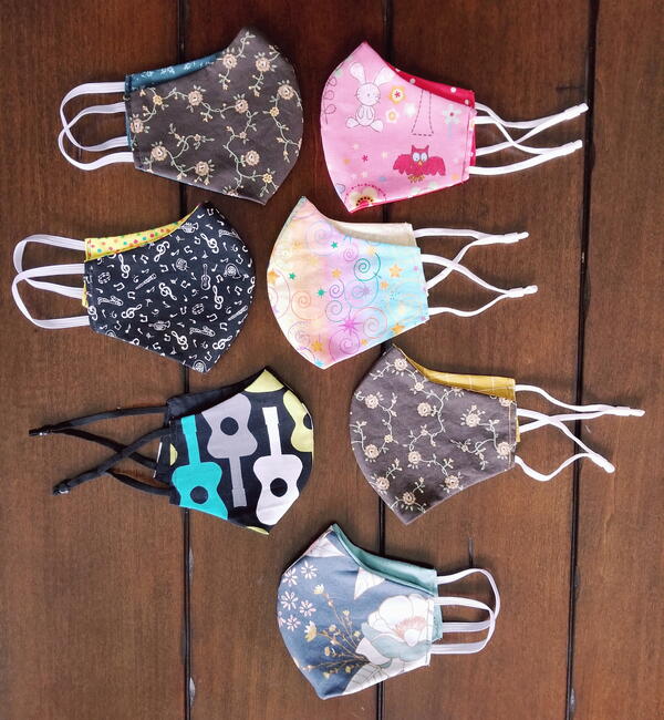Image shows several finished child size fabric face masks.