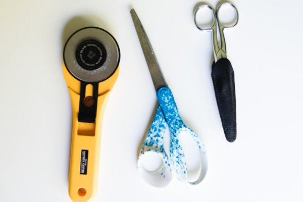 Image of the tools shown left to right: rotary cutter, non-fabric scissors, and fabric scissors.