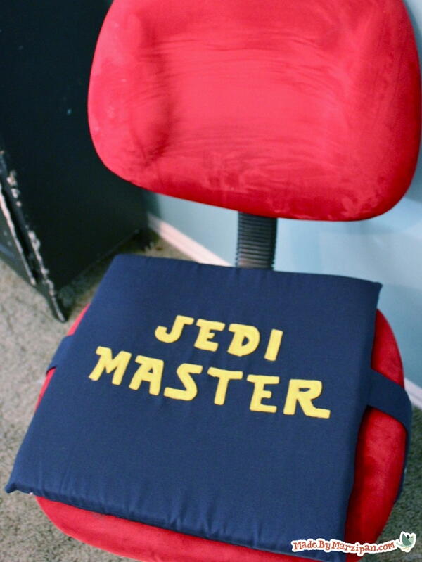 Image shows a red office chair with the DIY chair cushion on the seat.