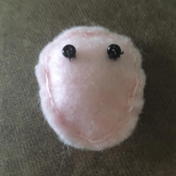 Image shows the stuffed and sewn felt face for the DIY Gnome Ornament.