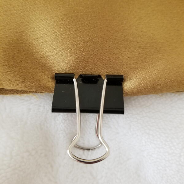 Binder clips holding fabric pieces together