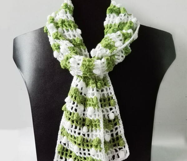 Image shows the Spring Green Lacy Crochet Mesh Scarf on a mannequin.