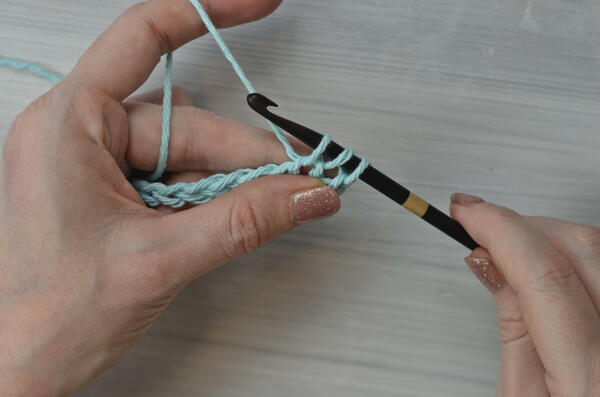 Image shows pulling up a loop for the Tunisian double crochet piece.