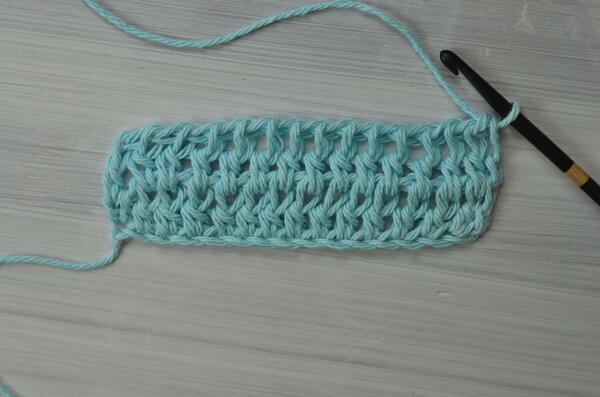 Image shows the current progress for the Tunisian double crochet piece.