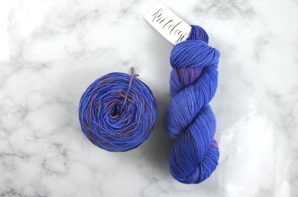 Images shows a wound yarn cake on the left and a hank of yarn on the right.