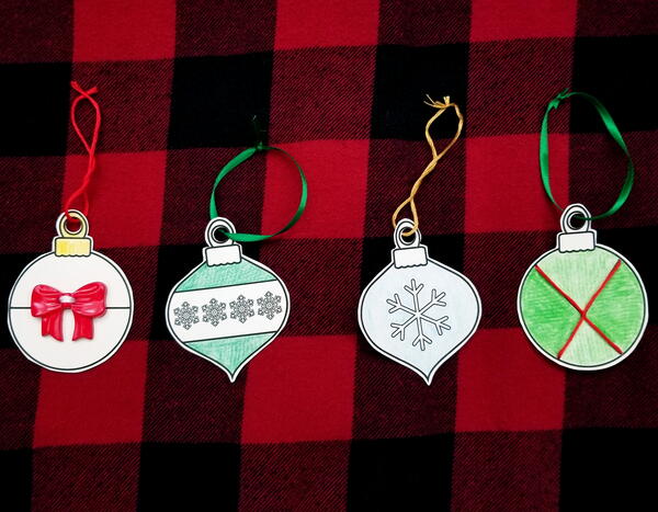 Image shows the finished Christmas Baubles Printable Lacing Cards cut out and ready to hang.