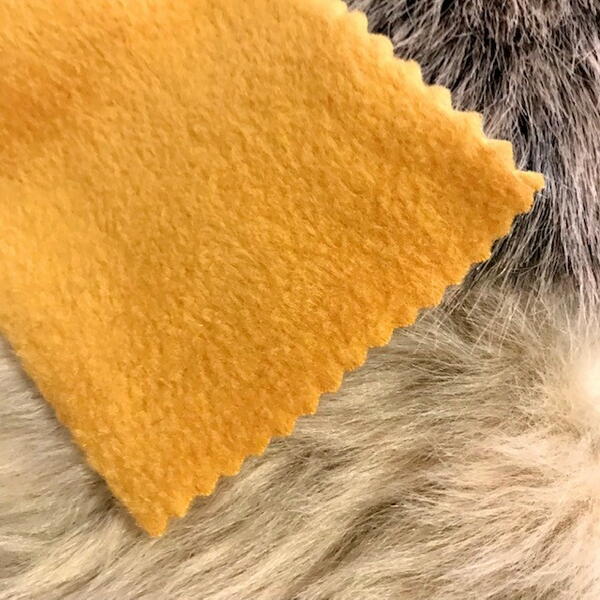 Image shows a piece of orange fleece sitting atop brown fur fabric.