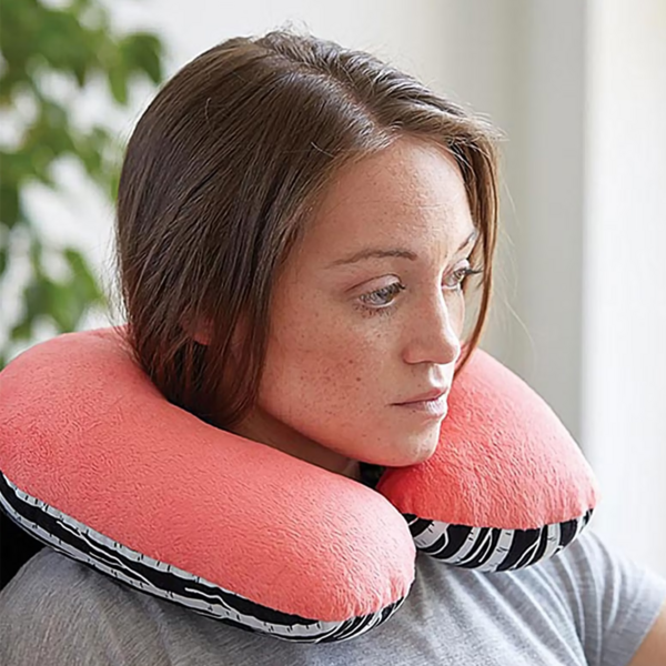 How to Make a Neck Pillow for Travel: Image shows a woman in slight side profile wearing the finished DIY neck pillow.