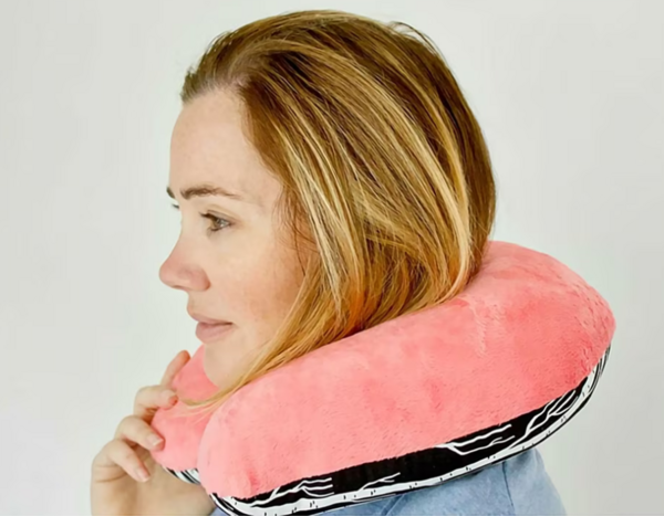 How to Make a Neck Pillow for Travel: Image shows a woman in side profile wearing the finished DIY neck pillow.