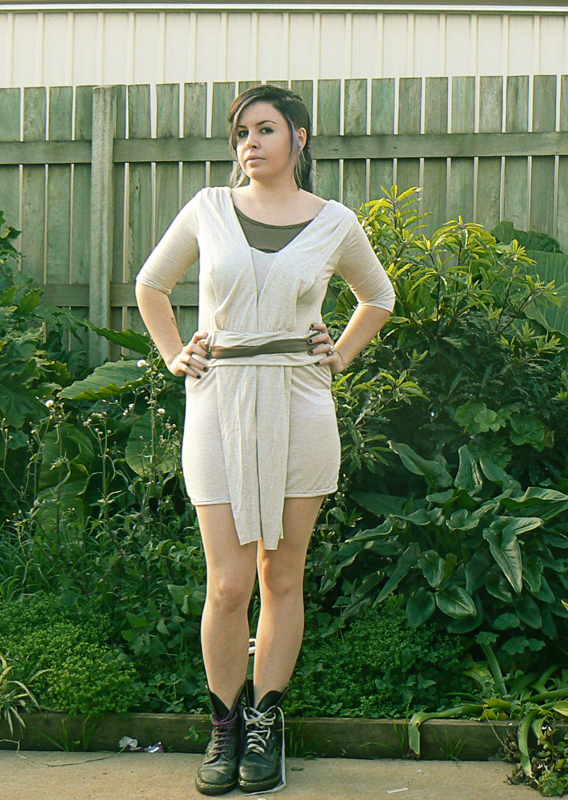 Image shows a woman standing in a yard in front of a fence wearing the Jedi Dress.