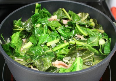Stir the greens and add more to the pot