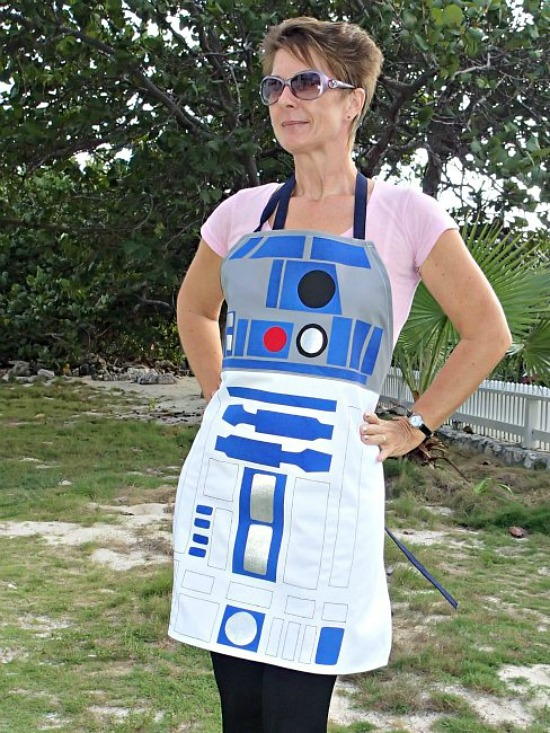 Image shows a woman in a yard wearing the Star Wars R2D2 DIY Apron.