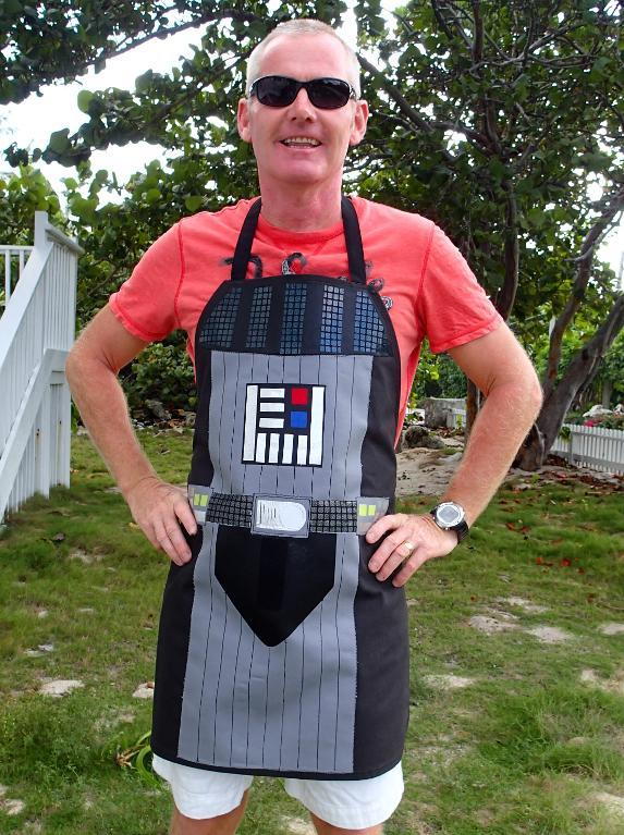 Image shows a man standing in a yard wearing the Darth Vader-Inspired Apron.