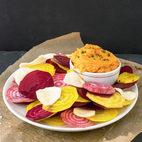 Healthy and delicious roasted carrot hummus with root vegetable chips