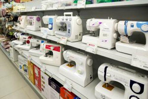 Images shows store shelves holding a variety of sewing machines.