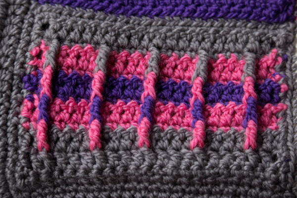 Image shows the bottom left panel of the Groovy Berry Crochet Messenger Bag Pattern free.