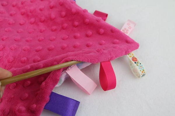 Image shows a chopstick being used to push the corners of the blanket out.