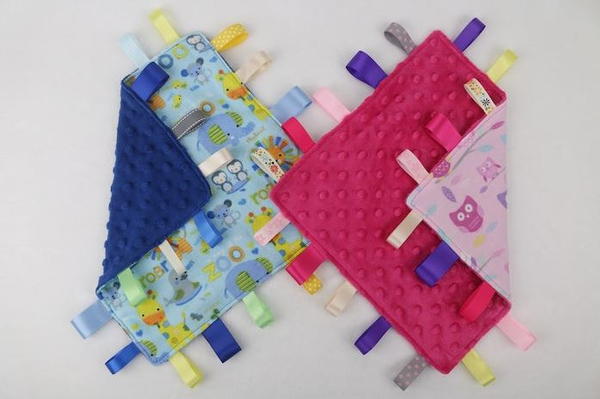 Image shows two finished tag blanket for babies.