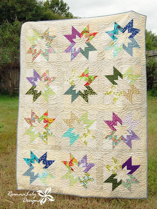 Image shows Jen's Scrappy Star Quilt in full (photographed outside).