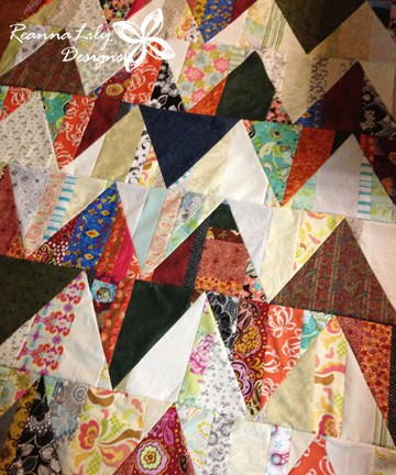 Image shows Jen's Scrappy Zigzag Triangle Quilt, up close.