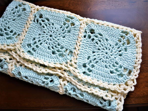 Image shows a folded blanket made up of the Magic Granny Squares.