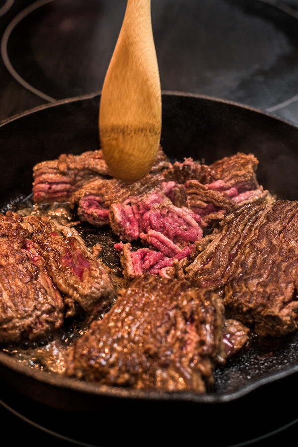 Brown the ground beef, breaking it up into pieces with a wooden spoon.