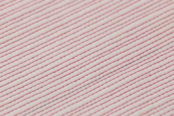 Image shows a close-up of the finished matchstick design on fabric.