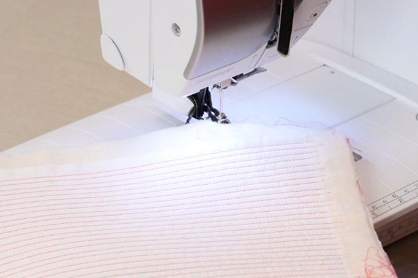 Image shows a machine and a fabric swatch showing the matchstick design.
