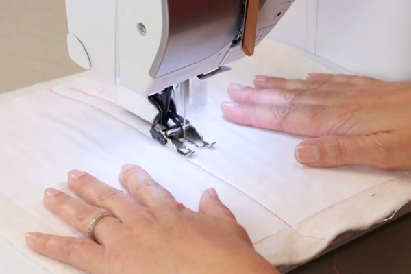 Image shows a machine sewing the straight line design.