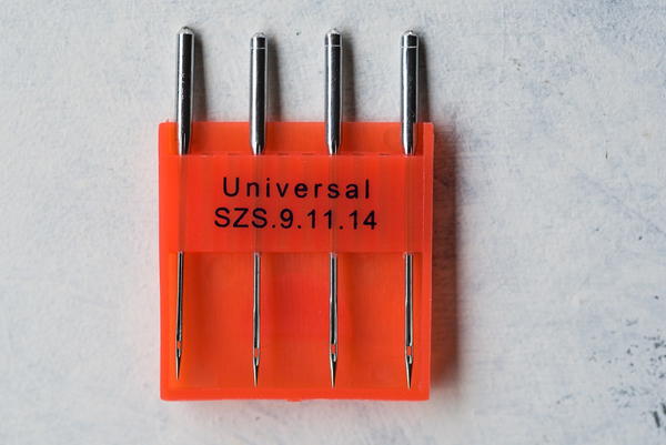 Image shows a package of universal machine needles.